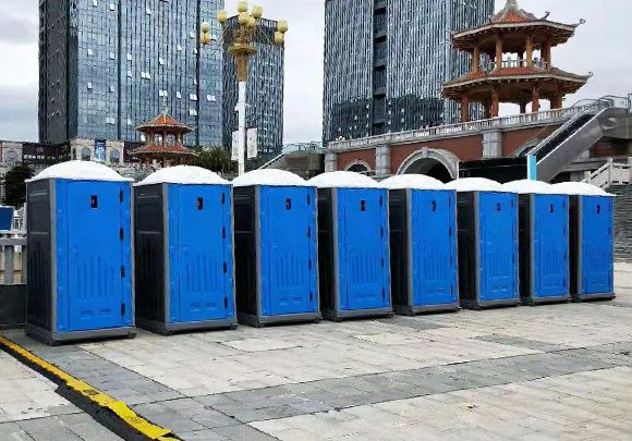 Eight EPS Portable toilets in front the high buildings outdoors
