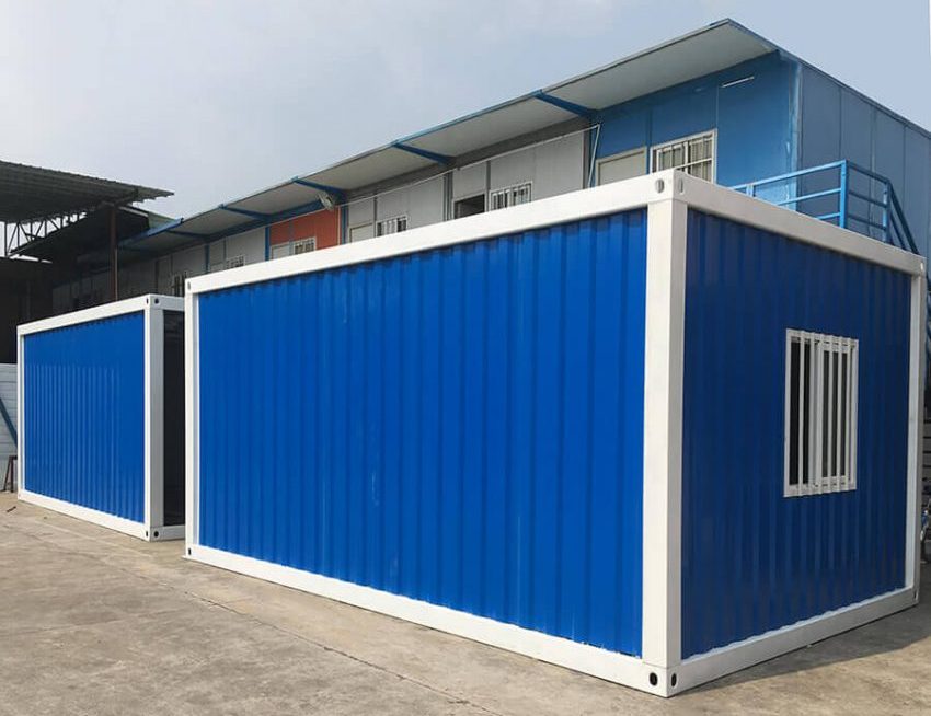 side of a blue Detachable Shipping Container House with windows and a door