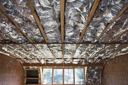 Fiberglass insulation installed in the sloping ceiling of a house
