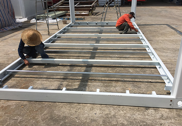 Two worker making a container house