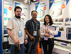 A group photo of three people in the shop