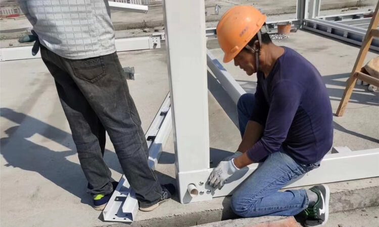 workers installing detachable container house